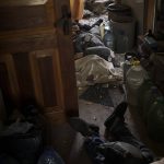 
              The bodies of three civilians lie in an apartment as Russian bombardments continue in a village recently retaken by Ukrainian forces near Kharkiv, Ukraine, Saturday, April 30, 2022. (AP Photo/Felipe Dana)
            