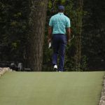 
              Tiger Woods walks over the Ben Hogan Bridge on the 12th hole during the second round at the Masters golf tournament on Friday, April 8, 2022, in Augusta, Ga. (AP Photo/Matt Slocum)
            