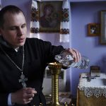 
              Orthodox priest Alexander Ivlev prepares for a service during the Easter celebration at the Saint Pantaleon church in Kramatorsk, Ukraine, Sunday, April 24, 2022. (AP Photo/Andriy Andriyenko)
            