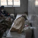 
              Irina, 61, left, stands next to her mother Klavidia, 91, who lies on a mattress next to another elderly woman as they wait to board a train fleeing from the war in Severodonetsk, at a train station in Pokrovsk, Ukraine, Monday, April 25, 2022. Russia unleashed a string of attacks against Ukrainian rail and fuel installations Monday, striking crucial infrastructure far from the front line of its eastern offensive. (AP Photo/Leo Correa)
            