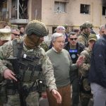 
              U.N. Secretary-General Antonio Guterres, center, looks at the houses destroyed by Russian shelling in Irpin, on the outskirts of Kyiv, Ukraine, Thursday, April 28, 2022. (AP Photo/Efrem Lukatsky)
            