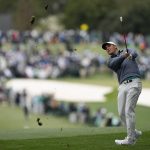 
              Scottie Scheffler hits from the rough on the first hole during the third round at the Masters golf tournament on Saturday, April 9, 2022, in Augusta, Ga. (AP Photo/David J. Phillip)
            