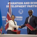 
              Britain's Home Secretary Priti Patel, left, shakes hands with Rwanda's Minister of Foreign Affairs Vincent Biruta, right, after signing what the two countries called an "economic development partnership" in Kigali, Rwanda Thursday, April 14, 2022. Britain's Conservative government has struck a deal to send some asylum-seekers thousands of miles away to Rwanda, a move that British opposition politicians and refugee groups condemned as inhumane, unworkable and a waste of public money. (AP Photo/Muhizi Olivier)
            