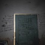 
              Writing can be seen on a wall and a door in the basement of a school in Yahidne, near Chernihiv, Ukraine, Tuesday, April 12, 2022. Residents say more than 300 people were trapped for weeks by Russian occupiers in  the basement of the school in Yahidne. They wrote the names of people who died during the Russian occupation of their village. (AP Photo/Evgeniy Maloletka)
            