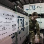 U.S. Air Force Airman Megan Konsmo, from Tacoma, Wash., checks pallets of helmets ultimately bound for Ukraine in the Super Port of the 436th Aerial Port Squadron, Friday, April 29, 2022, at Dover Air Force Base, Del. President Joe Biden asked Congress on Thursday for $33 billion to bolster Ukraine's fight against Russia, signaling a burgeoning and long-haul American commitment. (AP Photo/Alex Brandon)