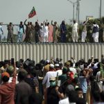 
              Supporters of ruling party Pakistan Tehreek-e-Insaf (PTI) chant slogans during a protest in Islamabad, Pakistan, Sunday, April 3, 2022. Pakistan's embattled Prime Minister Imran Khan said Sunday he will seek early elections after sidestepping a no-confidence challenge and alleging that a conspiracy to topple his government had failed. (AP Photo/Rahmat Gul)
            