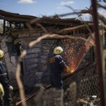 
              Ukrainian emergency service members remove debris from destroyed houses after a Russian rocket, hit by Ukraine's anti-aircraft system, stroke in a residencial area in Zaporizhzhia, Ukraine, Thursday, April 28, 2022. The strike came as parts of southern Ukraine prepare for a further advance by Russian forces who seek to strip the country of its seacoast. (AP Photo/Francisco Seco)
            