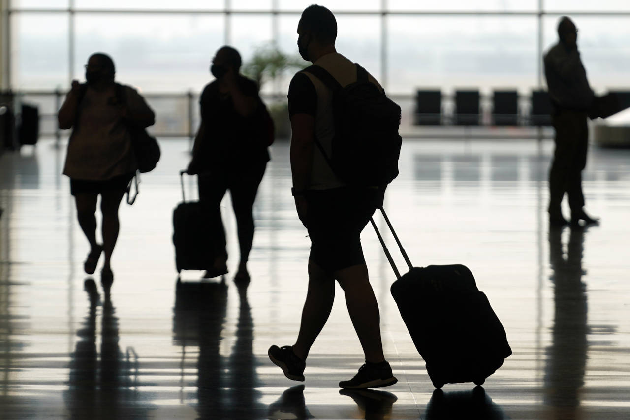 FILE - Travelers move through Salt Lake City International Airport on Aug. 17, 2021, in Salt Lake C...