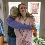 
              Karen McCulloch, left, embraces her daughter, Kirsten, as she wears her grandmother's robe in their home, Thursday, March 10, 2022, in Hillsborough, N.C. Mary Jacq McCulloch had long been the spark plug of her family, prone to dancing in supermarket aisles and striking up conversations with complete strangers. "She was really goofy," says her granddaughter who regularly wears the robe around the house. "I wish I could give her one more hug or hold her hand again." McCulloch, 87, died from COVID on April 21, 2020. (AP Photo/David Goldman)
            
