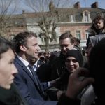 
              Current French President and centrist presidential candidate for reelection Emmanuel Macron meets residents in Denain, northern France, Monday, April 11, 2022 . French President Emmanuel Macron may be ahead in the presidential race so far, but he warned his supporters that "nothing is done" and his runoff battle with far-right challenger Marine Le Pen will be a hard fight. (AP Photo/Lewis Joly, Pool)
            