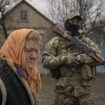 
              A woman waits for distribution of food products in the village of Motyzhyn, Ukraine, which was until recently under the control of the Russian military, Sunday, April 3, 2022. (AP Photo/Vadim Ghirda)
            