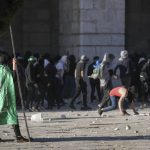 
              Palestinians clash with Israeli security forces at the Al Aqsa Mosque compound in Jerusalem's Old City Friday, April 15, 2022. (AP Photo/Mahmoud Illean)
            