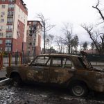 
              A damaged by shelling car is seen in a yard in Irpin, in the outskirts of Kyiv, Ukraine, Monday, April 11, 2022. (AP Photo/Evgeniy Maloletka)
            