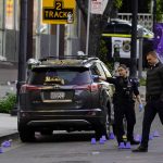 
              Investigators search for evidence in the area of a mass shooting In Sacramento, Calif. April 3, 2022. (AP Photo/Rich Pedroncelli)
            