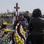 
              Irina Tromsa, left, mourns at the grave of her son Bogdan, 24, a Ukrainian paratrooper from the 95th Brigade killed during fighting against Russian troops in the north-east of the country, during his funeral at the cemetery in Bucha, in the outskirts of Kyiv, on Saturday, April 23, 2022. (AP Photo/Petros Giannakouris)
            
