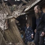 
              Oleg Mezhiritsky, right, and his mother Lidiya Mezhiritska, stand outside their house, damaged after a Russian attack in Kharkiv, Ukraine, Friday, April 8, 2022. (AP Photo/Felipe Dana)
            