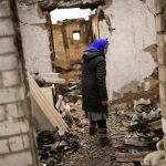 
              Valentyna Sherba, 68, enters her destroyed father's home in the aftermath of the battle between Russian and Ukrainian troops at the outskirts of Chernihiv, northern Ukraine, Saturday, April 23, 2022. (AP Photo/Francisco Seco)
            