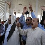 
              Supporters of Pakistani opposition parties chant slogans against the Prime Minister Imran Khan outside the National Assembly, in Islamabad, Pakistan, Sunday, April 3, 2022. Pakistan's president dissolved Parliament on Sunday setting the stage for early elections after the prime minister sidestepped a no-confidence move earlier in the day. (AP Photo/Anjum Naveed)
            