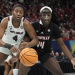 
              South Carolina's Aliyah Boston and Louisville's Olivia Cochran go after a loose ball during the first half of a college basketball game in the semifinal round of the Women's Final Four NCAA tournament Friday, April 1, 2022, in Minneapolis. (AP Photo/Eric Gay)
            