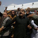 
              Lawmakers and supporters of the Pakistan Tehreek-e-Insaf party chant slogans in favor of their leader, Prime Minister Imran Khan, outside the National Assembly, in Islamabad, Pakistan, Sunday, April 3, 2022. Pakistan's president dissolved Parliament on Sunday setting the stage for early elections after the prime minister sidestepped a no-confidence move earlier in the day. (AP Photo/Anjum Naveed)
            