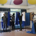 
              Municipality workers set up voting booths at a polling station in Montreuil, east of Paris, Saturday, April 23, 2022. French President Emmanuel Macron is facing off against far-right challenger Marine Le Pen in France's April 24 presidential runoff. (AP Photo/Lewis Joly)
            