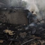 
              A man tries to extinguish a fire following a Russian bombardment at a residential neighborhood in Kharkiv, Ukraine, Tuesday, April 19, 2022. (AP Photo/Felipe Dana)
            