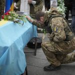 
              People pay their respect during the funeral ceremony for Ukrainian serviceman Volodymyr Karas, who died during the fighting with Russian troops at Independence square in Kyiv, Ukraine, Wednesday, April 20, 2022. (AP Photo/Efrem Lukatsky)
            