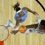 
              Kansas' Ochai Agbaji (30) misses the shot against North Carolina forward Armando Bacot during the second half of a college basketball game in the finals of the Men's Final Four NCAA tournament, Monday, April 4, 2022, in New Orleans. (AP Photo/Brynn Anderson)
            