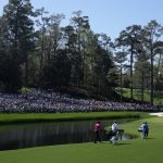 
              Tiger Woods, left, walks with Joaquin Niemann, of Chile, on the 16th fairway during the first round at the Masters golf tournament on Thursday, April 7, 2022, in Augusta, Ga. (AP Photo/David J. Phillip)
            