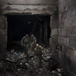 
              Ukrainian soldiers walk in a building previously used by Russian soldiers as a temporary base in Malaya Rohan, on the outskirts of Kharkiv, Ukraine, Tuesday, April 12, 2022. (AP Photo/Felipe Dana)
            