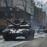 
              Ukrainian tanks move in a street in Irpin, in the outskirts of Kyiv, Ukraine, Monday, April 11, 2022. (AP Photo/Evgeniy Maloletka)
            