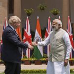 
              Indian Prime Minister Narendra Modi shakes hand with his British counterpart Boris Johnson before their delegation level talks in New Delhi, Friday, April 22, 2022. Johnson is expected to help move India away from its dependence on Russia by expanding economic and defense ties when he meets with his Indian counterpart Friday, officials said. (AP Photo/Manish Swarup)
            