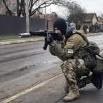 
              A Ukrainian serviceman secures the retreat of fellow soldiers who checked bodies lying on the street for booby traps in the formerly Russian-occupied Kyiv suburb of Bucha, Ukraine, Saturday, April 2, 2022. As Russian forces pull back from Ukraine's capital region, retreating troops are creating a "catastrophic" situation for civilians by leaving mines around homes, abandoned equipment and "even the bodies of those killed," President Volodymyr Zelenskyy warned Saturday. (AP Photo/Vadim Ghirda)
            