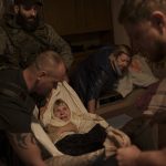 
              Volunteers evacuate an elderly woman out of her apartment at a frontline neighborhood as Russian bombardments continue in Kharkiv, Ukraine, Monday, April 25, 2022. (AP Photo/Felipe Dana)
            