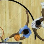 
              North Carolina guard Puff Johnson, right, shoots against Kansas forward K.J. Adams during the first half of a college basketball game in the finals of the Men's Final Four NCAA tournament, Monday, April 4, 2022, in New Orleans. (AP Photo/Brynn Anderson)
            