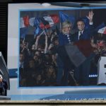 
              A public TV screen shows a news on French President Emanuel Macron winning a second term Monday, April 25, 2022, in Tokyo. Japan welcomed the reelection of Macron as key to the unity of Group of Seven at a time its members need to work together to end Russia's invasion of Ukraine as soon as possible. (AP Photo/Eugene Hoshiko)
            
