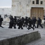 
              Israeli police enter the Al Aqsa Mosque compound where they clashed with Palestinian protesters following early morning prayers in Jerusalem's Old City, Friday, April 22, 2022. Israeli police and Palestinian youths clashed again at the major Jerusalem holy site sacred to Jews and Muslims on Friday despite a temporary halt to Jewish visits to the site, which are seen as a provocation by the Palestinians. (AP Photo/Mahmoud Illean)
            
