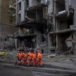 
              Clean-up crews prepare to work at the site of an explosion in Kyiv, Ukraine on Friday, April 29, 2022. Russia struck the Ukrainian capital of Kyiv shortly after a meeting between President Volodymyr Zelenskyy and U.N. Secretary-General António Guterres on Thursday evening. (AP Photo/Emilio Morenatti)
            