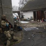 
              Ukrainian soldiers operate inside an abandoned house during a military sweep to search for possible remnants of Russian troops after their withdrawal from villages in the outskirts of Kyiv, Ukraine, Friday, April 1, 2022. (AP Photo/Rodrigo Abd)
            
