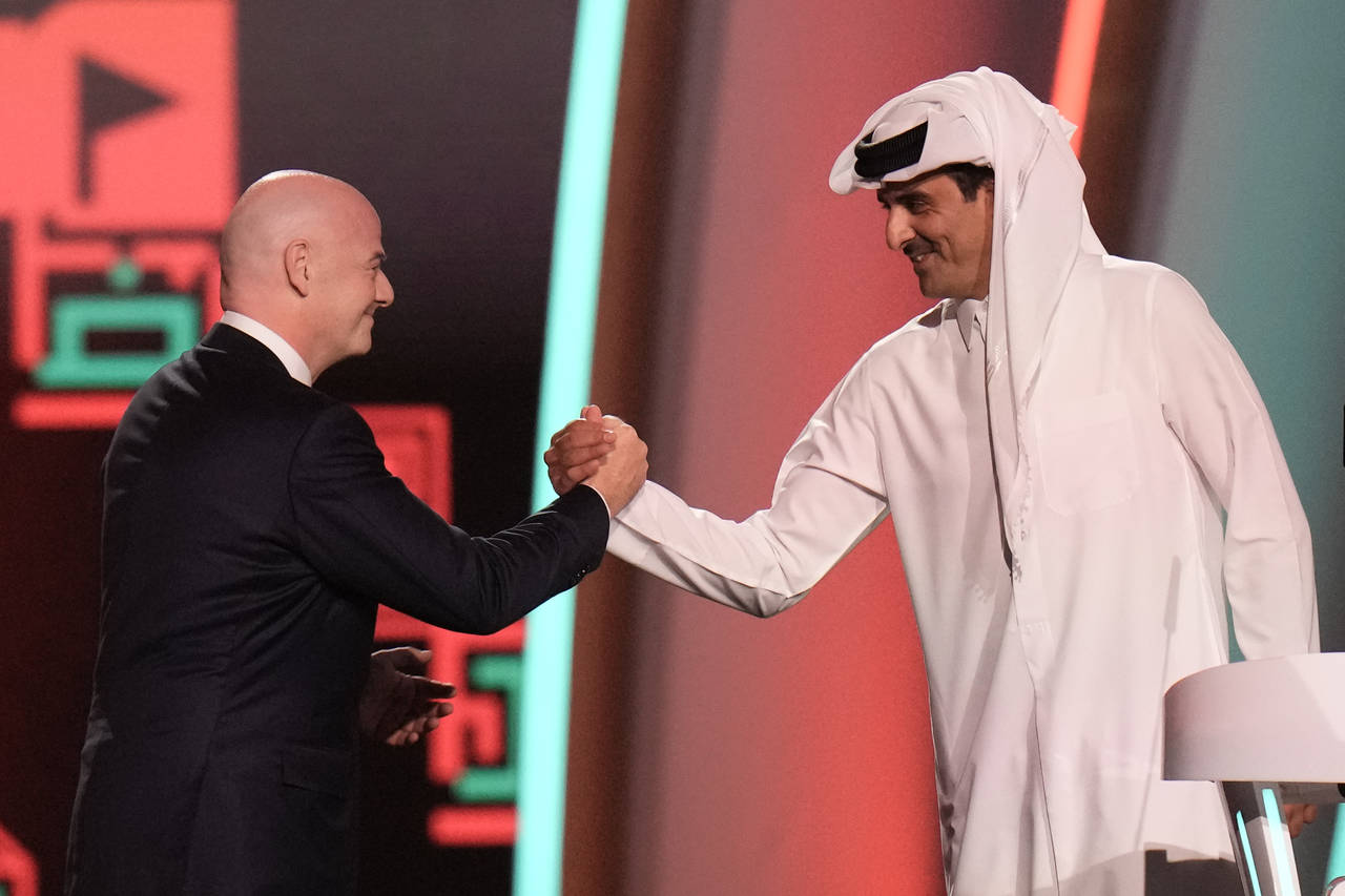 FIFA President Gianni Infantino, left, and Emir of Qatar Sheikh Tamim bin Hamad Al Thani shake hand...
