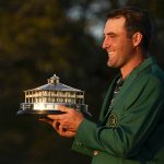 
              Scottie Scheffler holds the championship trophy after winning the 86th Masters golf tournament on Sunday, April 10, 2022, in Augusta, Ga. (AP Photo/Robert F. Bukaty)
            