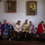 
              Ukraine women wait for the start of a religious service to commemorate the fallen during the Russian occupation in Zdvyzhivka, on the outskirts of Kyiv, on Saturday, April 30, 2022. (AP Photo/Emilio Morenatti)
            