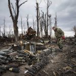 
              An interior ministry sapper collects unexploded shells, grenades and other devices in Hostomel, close to Kyiv, Ukraine, Monday, April 18, 2022. (AP Photo/Efrem Lukatsky)
            