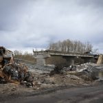 
              A destroyed car seen at a destroyed bridge in the village of Dymer, in Kyiv region, Ukraine, Tuesday, April 12, 2022. (AP Photo/Efrem Lukatsky)
            