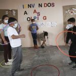 
              Victor Rodas, left, and Eduardo Pacheco, participate in a physical education exercise at the start of class at Casa Kolping, an alternative education center where child migrants from two pastor-run shelters take classes every weekday morning, in Ciudad Juarez, Mexico, on Tuesday, March 28, 2022. The two students, both 12 years old, fled gang violence back home in Honduras and the Mexican state of Guerrero, respectively. (AP Photo/Christian Chavez)
            