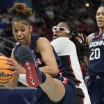 
              UConn's Evina Westbrook grabs a ball in front of Stanford's Francesca Belibi during the first half of a college basketball game in the semifinal round of the Women's Final Four NCAA tournament Friday, April 1, 2022, in Minneapolis. (AP Photo/Eric Gay)
            