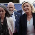 
              French far-right leader Marine Le Pen, right, flanked by chief executive officer of French TV Group France Televisions Delphine Ernotte, arrives at a television recording studio for a debate with centrist candidate and French President Emmanuel Macron, Wednesday, April 20, 2022 in La Plaine-Saint-Denis, outside Paris. In the climax of France's presidential campaign, centrist President Emmanuel Macron and far-right contender Marine Le Pen meet in a one-on-one television debate that could prove decisive before Sunday's runoff vote. (AP Photo/Francois Mori)
            