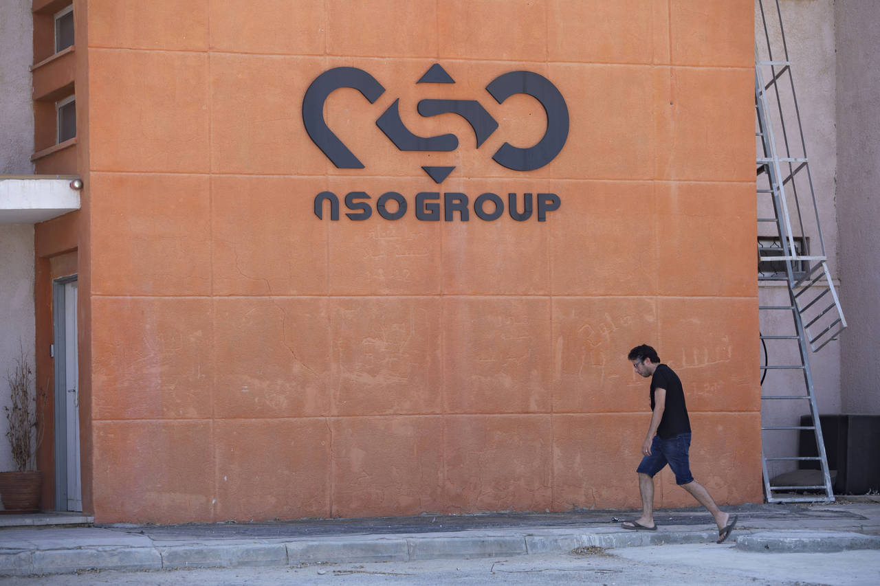 FILE - A logo adorns a wall on a branch of the Israeli tech company NSO Group, near the southern Is...