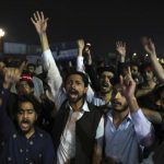 
              Supporters of former Prime Minister Imran Khan chant slogans during a protest after a no-confidence vote, in Islamabad, Pakistan, Sunday, April 10, 2022. Pakistan’s political opposition toppled Khan in a no-confidence vote in Parliament early Sunday after several political allies and a key party in his ruling coalition deserted him. (AP Photo/Rahmat Gul)
            