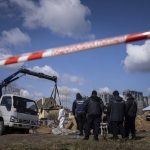 
              Forensic scientists and police inspect dead bodies of local residents after removing them from a mass grave in Bucha, on the outskirts of Kyiv, Ukraine, Monday, April 11, 2022. (AP Photo/Evgeniy Maloletka)
            